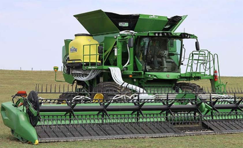 A combine outfitted with an air delivery seeding system.