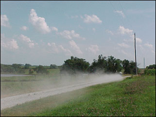Image of unpaved road causing dust.