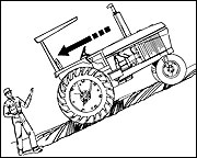 Man standing downhill of a tractor that is rolling downhill because parking brake was not set.