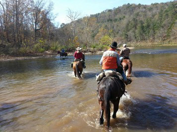 A group riding through a stream.