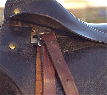 English saddle with safety-release stirrup bars.