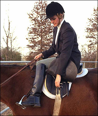 A rider adjusting the cinch.