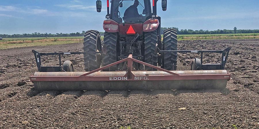 Planter making beds on farmland.