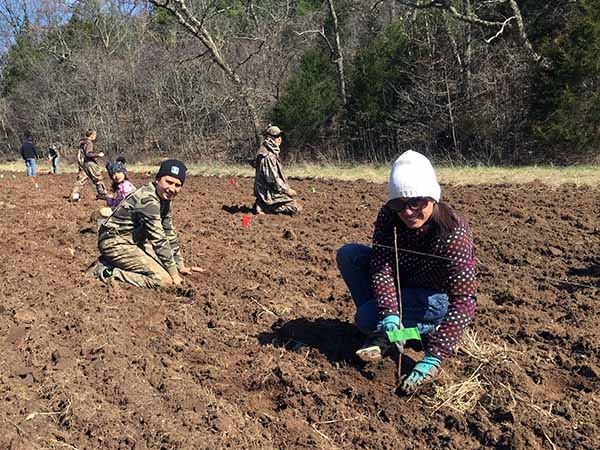 A group of people preparing a tree planting site.