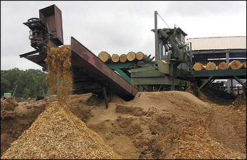 Bark and other sawmill residues being added to a pile.