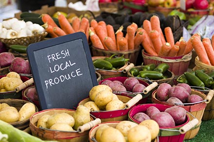 Fresh local produce including carrots, peppers, onions and potatoes.