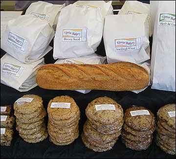 Baked goods on a table in a farmers market stall. Eric Reuter photo.