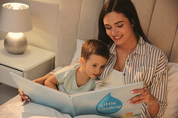 mom and child reading in bed