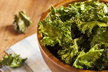 Kale chips in a wooden bowl