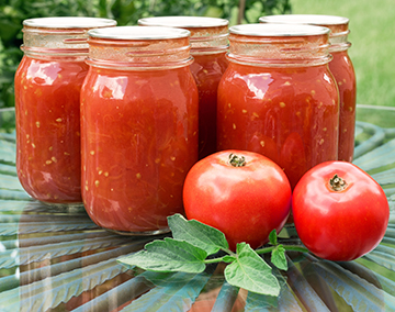 five jars of canned tomatoes