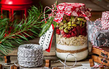 a mason jar with pistachios and dried cranberries