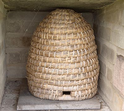 A skep, a basket-woven beehive