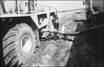 Biosolids are transferred from the tanker to the field applicator