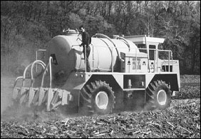 Applicator injecting biosolids into crop land