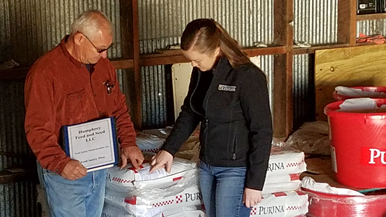 Vancell and Brenda reading feed labels 