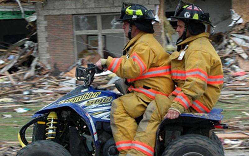 two people in emergency gear on an ATV