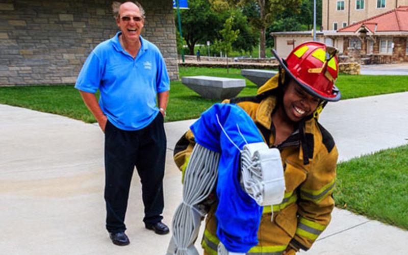 firefighter laughing with educator