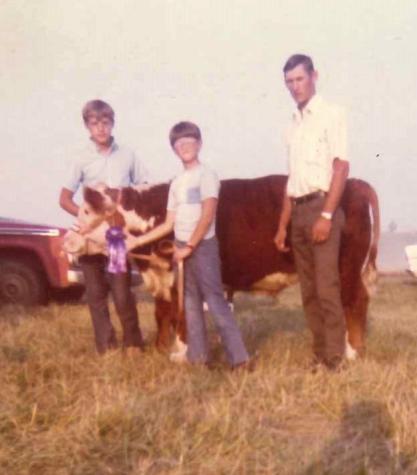 Mike Kateman, center, with his prize-winning calf, Boots. Also pictured: Kateman's cousin Doug Boland, left; and Kateman's father, Donald Kateman.