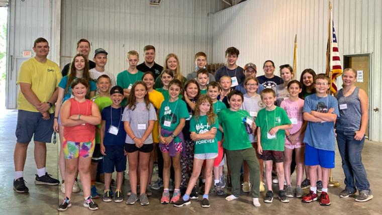 Justin Luster, left, with 2021 Boone County 4-H day campers.