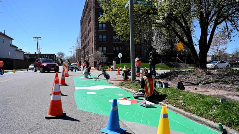 St. Louis ArtWorks youths and Washington University grad students paint one of four West End intersections as part of a traffic-calming project.