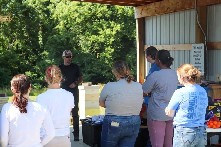 Travis Harper gives students a rundown of the day before they suit up and get to the hives at MU Southwest Center in Mount Vernon.