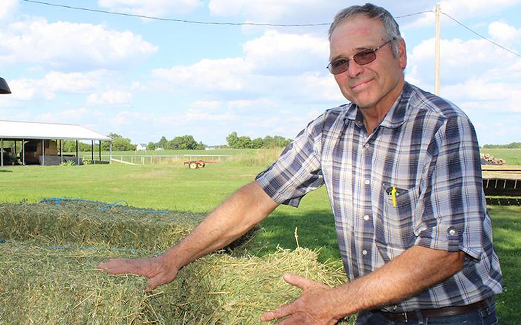 Glenn Obermann with hay