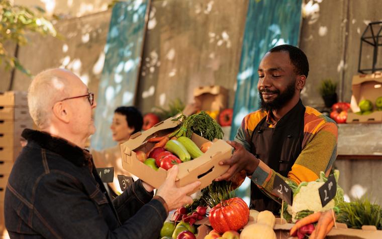 Man buying produce at a farmers market.