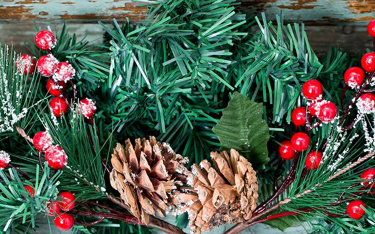 Christmas decoration of mistletoe, holly with berries, ivy and pine cones