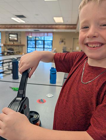 Youth using a button maker