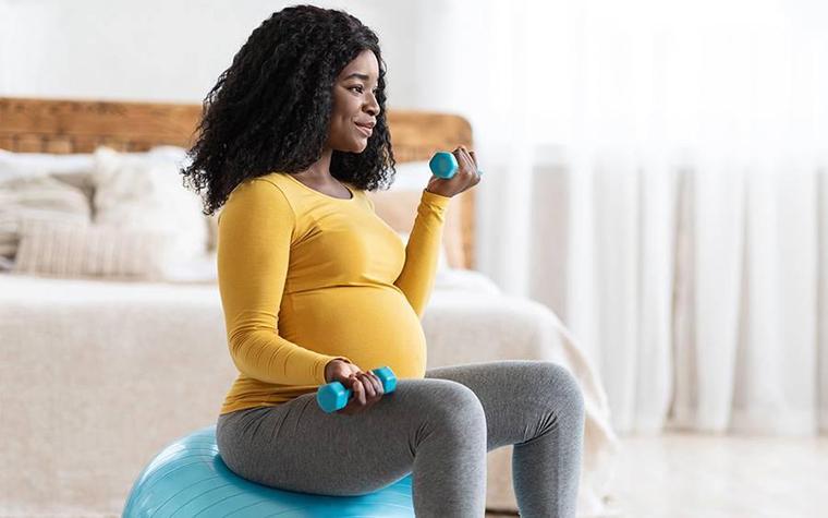 Pregnant woman exercising at home