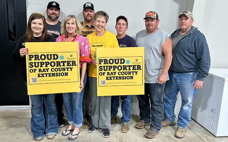 Supporters of Ray County Extension holding signs