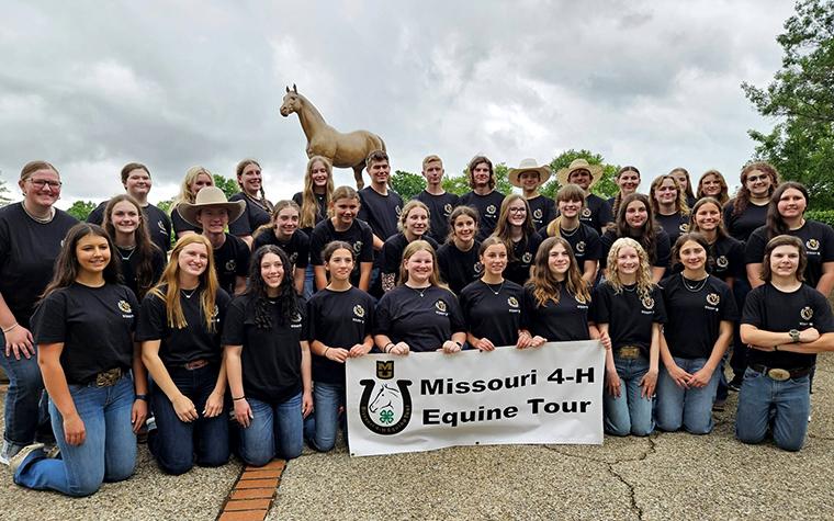 Missouri 4-H youths with Missouri 4-H Equine Tour banner