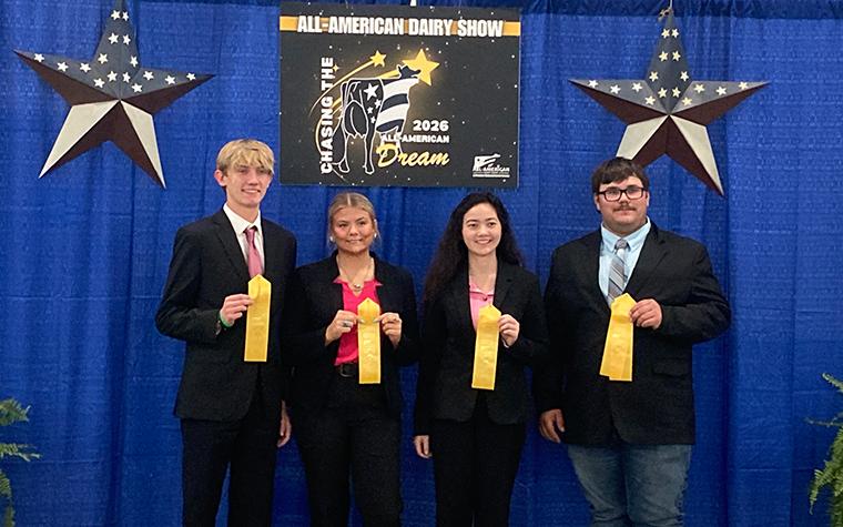 Four youths holding ribbons