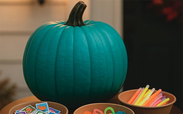 A teal pumpkin amid non-food trick-or-treat items