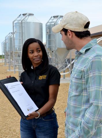 Seanicaa Edwards, left,  swine economist for MU Extension’s Commercial Agriculture program, with Joseph Dolginow, MU graduate research assistant in agricultural economics. The Commercial Ag program is one example of the land-grant university’s role in advJessica Salmond, MU Cooperative Media Group 