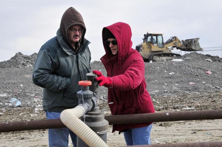 MU researcher David Brune and Cynthia Mitchell, landfill and recovery superintendent with the Columbia Public Works Department, inspect a methane well at the city landfill, where 51 wells siphon methane off decomposing mixed trash. That methane fuels geneRoger Meissen/MU Cooperative Media Group