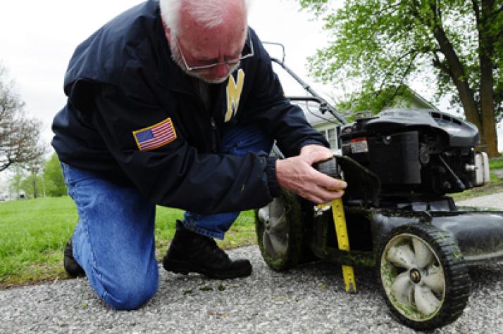 Experts suggest that homeowners adjust mowers to cut grass at a height between 3 and 4 inches. Fresenburg measures from the ground to the bottom of the cutting blade because factory adjustments can be inaccurate. Roger Meissen/MU Cooperative Media Group