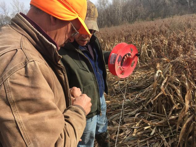 Harry Cope and Larry Ware measure fencing for milo grazing at Ware’s Lincoln County farm.