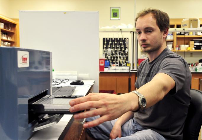 Peter Vargovic, a post-doctorate student, put test tubes of labeled bulls sperm cells into EasyCyte flow cytometer, a machine that measures the percentage of bad sperm cells in bull semen samples, based on fluorescent labeling that distinguishes between gJessica Salmond/MU Cooperative Media Group