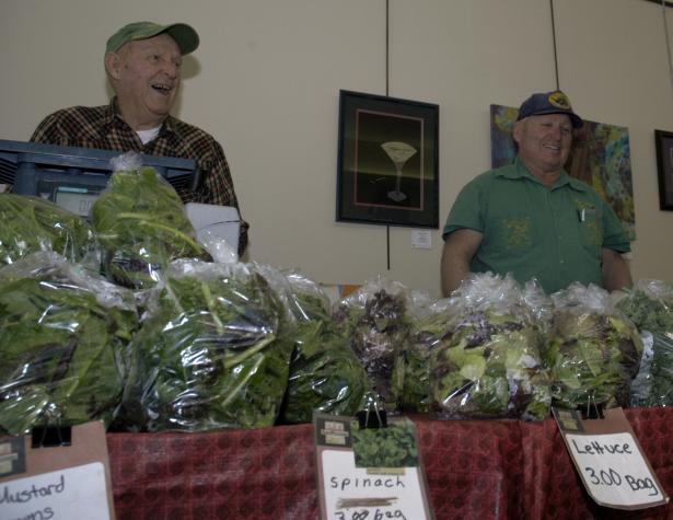 Jim Thomas Sr. (left) and son Jim Thomas Jr. of Share Life Farms sell produce grown in a high tunnel. University of Missouri Cooperative Media Group