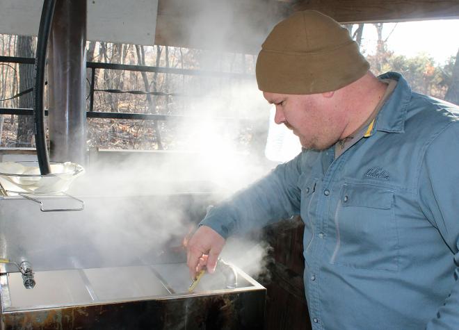 It takes 40 gallons of sap to make a gallon of maple syrup. Veteran Jeremy Beaver returned to his rural Missouri roots after serving as a Marine in Iraq. He and his family run a maple syrup business on 40 acres of woods near Mark Twain Lake.Photo by Linda Geist