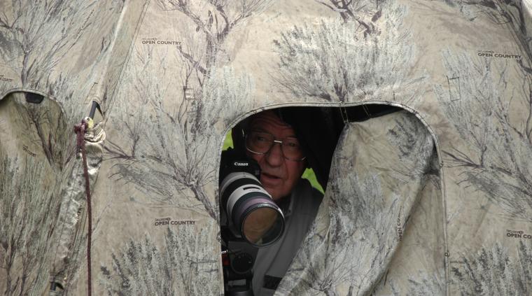 Photographer Glenn Chambers sits within a photographer's blind-a camouflaged tent he uses to covertly observe and photograph wildlife.Photo by Curt Wohleber