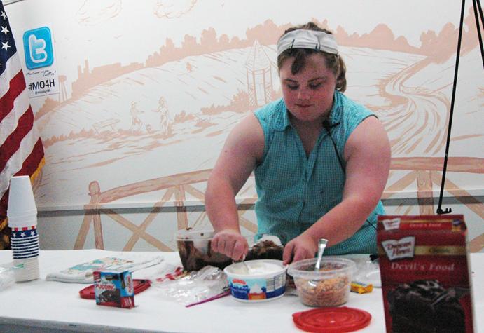 Marion County 4-H member Marissa Todd demonstrates cooking skills at the 2015 Missouri State Fair. Marissa, who has Down syndrome, has served as 4-H club president and camp counselor. Photo by Linda Geist