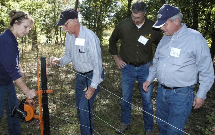 Charlotte Clifford-Rathert demonstrates some new portable fencing options that offer flexibility and ease of use for rotational grazing, immunizations, hoof trimming or training. Photo by Linda Geist