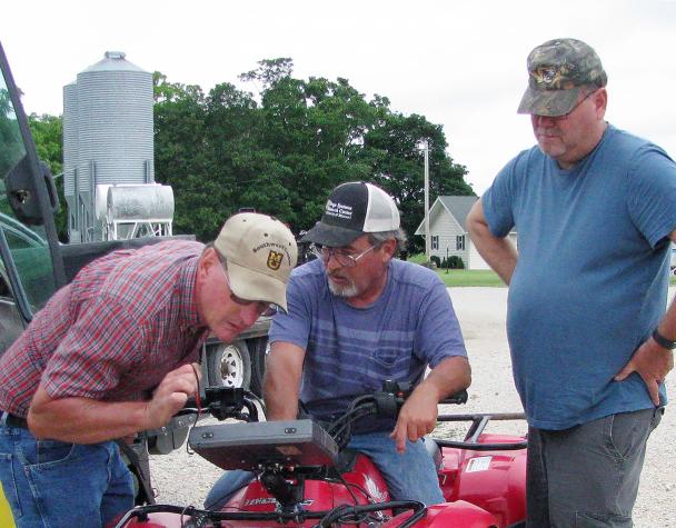 Purdy, Mo., dairy farmer Charles Fletcher, left, works with MU researcher Danny England, center, and MU Extension dairy specialist Stacey Hamilton, right to learn how to measure and manage forage through the Grazing Wedge. USDA recently awarded MU a grantPhoto by Linda Geist