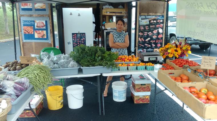 Pathoumma Meusch helps customers at farmers markets learn about new foods and how to prepare them. She and her husband, Eric, sell produce and meat at farmers markets and through a CSA. Photo courtesy of Eric Mensch