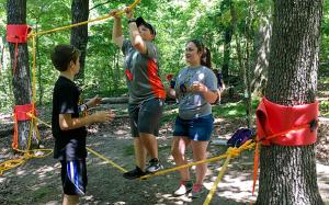Kids on a rope course during 4-H camp. 