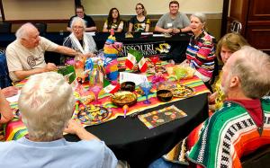 Senior citizens sitting around a table.