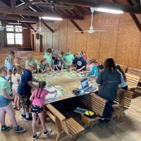 A Missouri 4-H teen leader presents this year’s Ag Innovators Experience activity to a group at a 4-H camp in central Missouri.