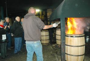 Artisans char whiskey barrels at Barrel 53 in Higbee during the recent White Oak, Whiskey & Wine tour. Photo by Linda Geist